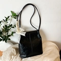 Minimalist black pleated hobo bag with vintage texture and cream lace bow detail - Black