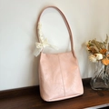 Pink pleated leather shoulder bag with white lace bow decoration and textured finish - Pink