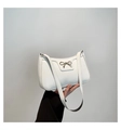 Chic white baguette shoulder bag featuring a metallic gold bow and sleek PU leather - White