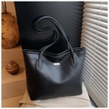 Detail of black lychee texture leather tote bag with a metallic rectangular logo plate - Black