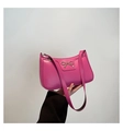 Hot pink PU leather hobo bag with a decorative gold metal bow shown in hand - Rose Red