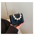 Mini black heart-embossed crossbody bag with elegant pearl handle and gold chain strap - Black