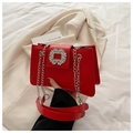 Elegant red shoulder bag with rhinestone buckle and silver chain on white background - Red