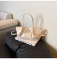 Detail of a chic ivory dumpling bag featuring a delicate bow knot and sleek PU leather finish - Off White
