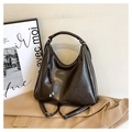 Detail of dark brown leather convertible backpack with tassel and vertical zipper pocket - Coffee