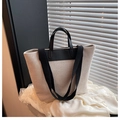 Minimalist beige canvas tote bag with black leather handles and shadow detail - Black