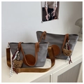 Detailed macro view of gray nylon tote bags with brown faux leather handles and bear charms - Light Gray