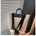 Minimalist canvas tote bag with black leather handles and beige woven fabric texture - Coffee
