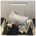 Detail of silver cat-ear shaped handbag with lace bow and metal plate on leather seat - Silver With Pendant
