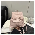 Detail of pink mini backpack featuring bow accents and elegant ruched flap design - Pink