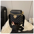 Detail of crossbody bag with golden heart clasp and geometric patterned canvas material - Black