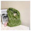 Close-up of grass green woven tote bag featuring white pearl wave patterns and crochet texture - Green