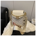Detail of vintage crossbody bag with gold heart lock and printed monogram pattern - White