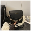 Close-up of black leather crossbody bag with gold fashion lettering and chain detail - Black