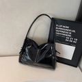 Glossy black patent leather tote bag with knot detail and chic slouchy silhouette - Black
