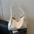 Minimalist white glossy tote bag with pleated design and knot drawstring details - Off White