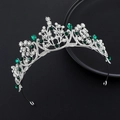 Detail of silver crown with emerald green gems and sparkling crystals in baroque style - Silver Green Stone