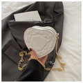 Chic white heart-shaped quilted shoulder bag with gold chain strap on grey blazer - White