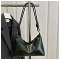 Detail of dark green hobo bag featuring knotted shoulder strap and gold hardware - Green
