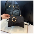 Chic black sequin handbag with gold flower clasp and unique geometric bottom design - Black