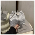 Detail of silver pleated bucket bag with metallic butterfly clasp and pearl drawstring - Silver