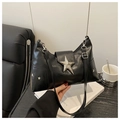 Detail of black crescent bag featuring large metal star buckle and star-shaped rivets - Black