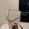 Champagne gold glitter crossbody bag with S-shaped metal logo and fringe detail - Gold