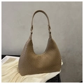 Close-up of brown crocodile pattern faux leather on a stylish hobo shoulder bag - Khaki
