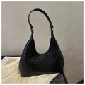 Detail shot of black woven leather shoulder bag with gold hardware on white silk - Black