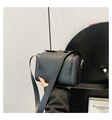 Close-up of black litchi grain leather crossbody box bag with gold metallic clasp - Black