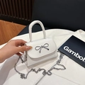White mini crossbody bag with a silver metal bow buckle and elegant chain strap - White
