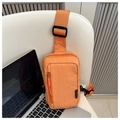 Detail of orange nylon chest bag with fashion label on a white chair next to a laptop - Fashion Design (9496-F) / Orange