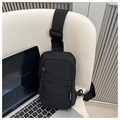 Detail of minimalist black nylon chest bag with adjustable strap and front zipper pocket - Fashion Design (9496-F) / Black