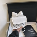 Detail of white mini crossbody bag with a large bow and polka dots in a gift box - White
