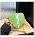 Green heart-shaped crossbody bag featuring white lightning pattern and silver zipper - Green