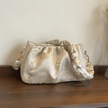 Fashionable champagne sequin cloud bag with ruched texture and golden hardware accents - Off White
