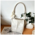 Creamy white shoulder bag with glossy crinkle texture and delicate lace bow detail - Off White