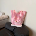 Pink and white striped canvas tote bag with pink straps on a black leather sofa - Pink Side A (Striped)