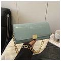 Detail of light blue croc-embossed handbag with gold clasp and chain strap - Lake Blue