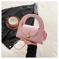 Pink minimalist half-moon crossbody bag with golden clasp and smooth leather texture - Pink