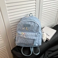 Quilted light blue backpack with bow embroidery and faux fur pendant on black seat - Large With Pendant / Blue