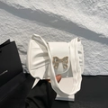 White pleated shoulder bag with a large bow design and golden metallic hardware - White