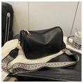 Detail of black crossbody bag with decorative geometric fabric strap and gold hardware - Black
