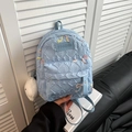 Light blue quilted mini backpack with letter embossing and white plush keychain accessory - Small With Pendant / Blue