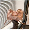Detail of pink pleated bucket bag with marble bead handle and white text printing - Pink