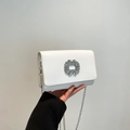 White leather shoulder bag with a round crystal buckle and silver chain strap - White