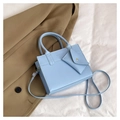 Detail of light blue faux leather handbag with brand embossing and envelope charm - Blue