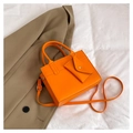 Detail of orange leather crossbody bag with envelope pouch and gold hardware accents - Orange