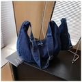 Detailed macro view of dark blue denim crescent hobo bag with wide shoulder strap - Dark Blue