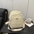 Chic beige nylon convertible backpack and shoulder bag with pleated texture and metal logo - White